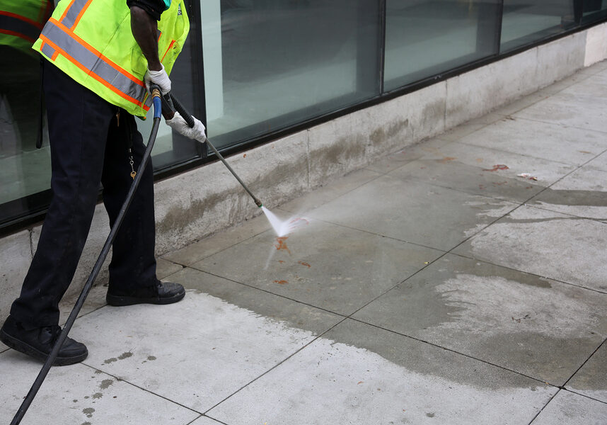 man power washing the concrete floor